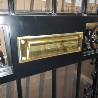 brass mail slot in security door in buffalo new york