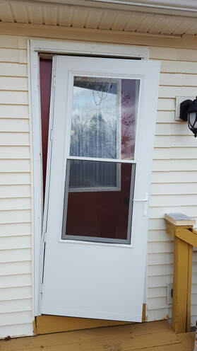 storm door damaged by high winds