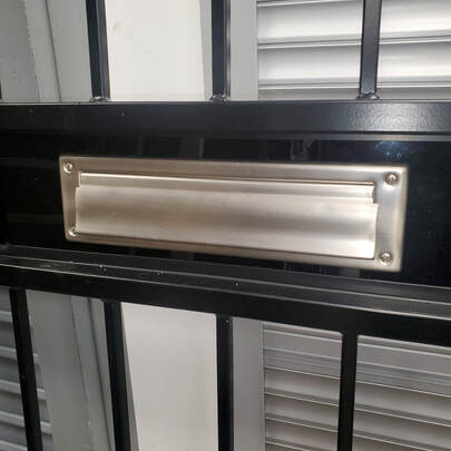 silver mail slot in security door in buffalo new york